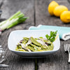 Bowl of Foglie d’ulivo olive leaf pasta with decorative background