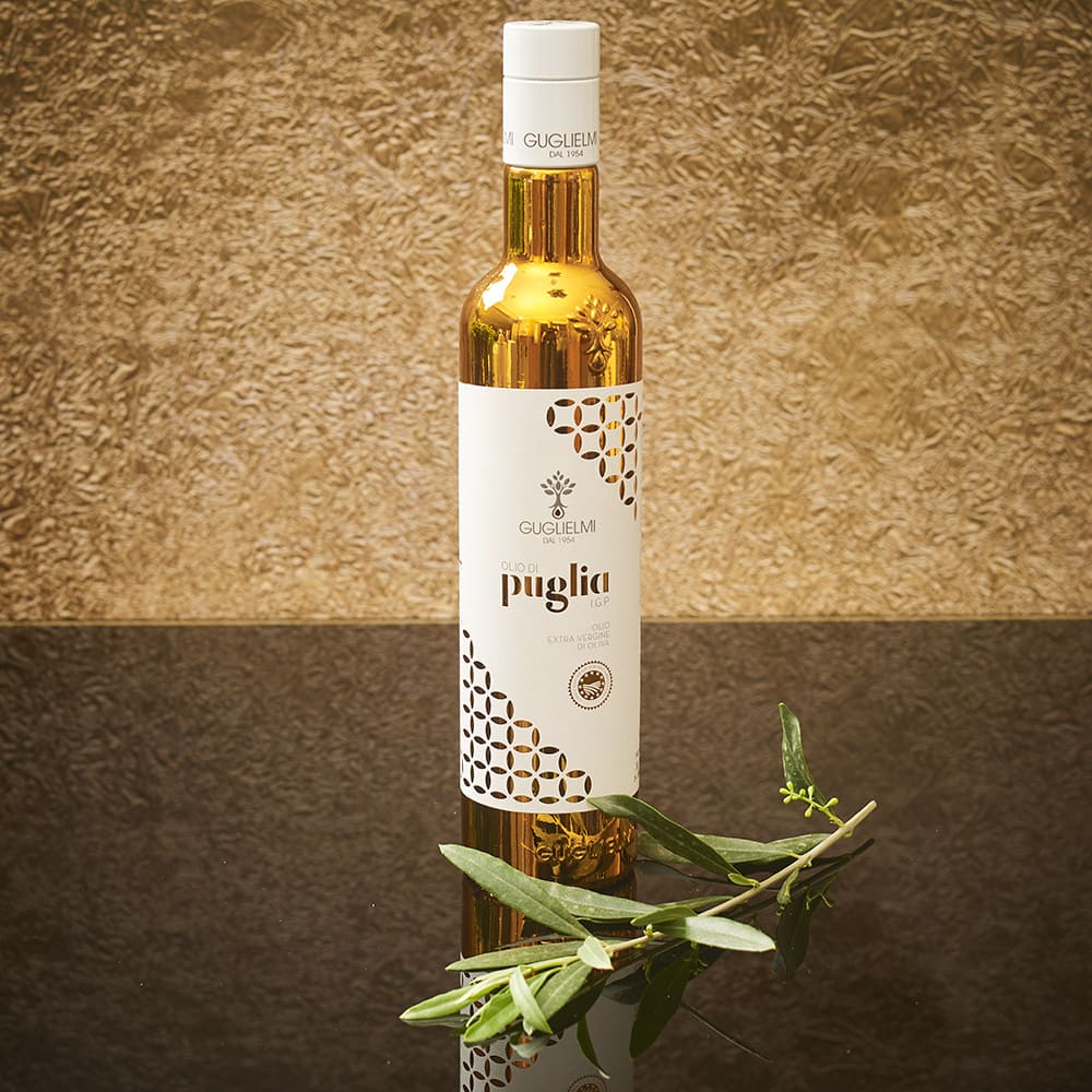 Bottle of Olio di Puglia cold pressed olive oil with decorative background