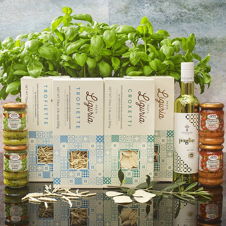 Organic Italian premium gift box for foodies and lovers of Italian food. Guglielmi Puglia extra virgin olive oil in a stunning metallic Green bottle. Sacla' organic basil and tomato Pesto Liguria Croxetti and Trofiette pasta with basil plant.