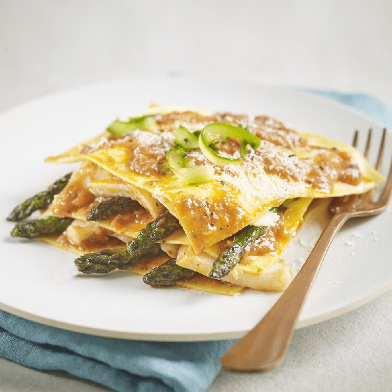 Creamy tomato and mascarpone pasta sauce lasagne with asparagus spears