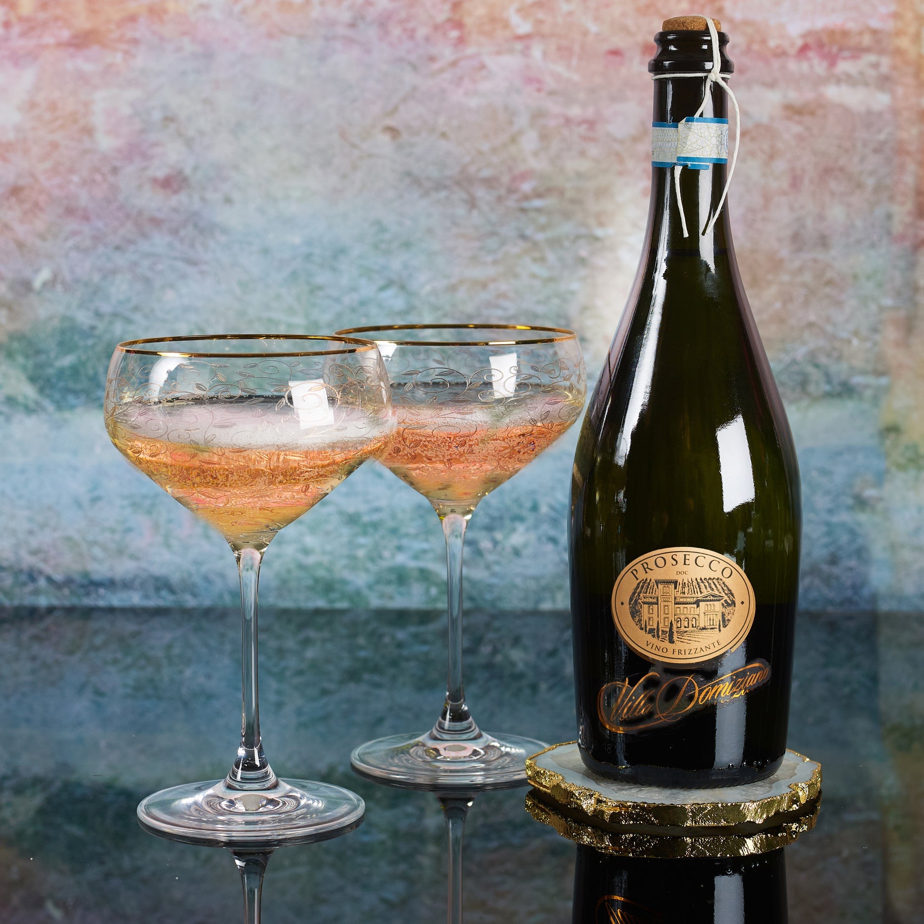 Prosecco DOC bottle and two poured glasses.